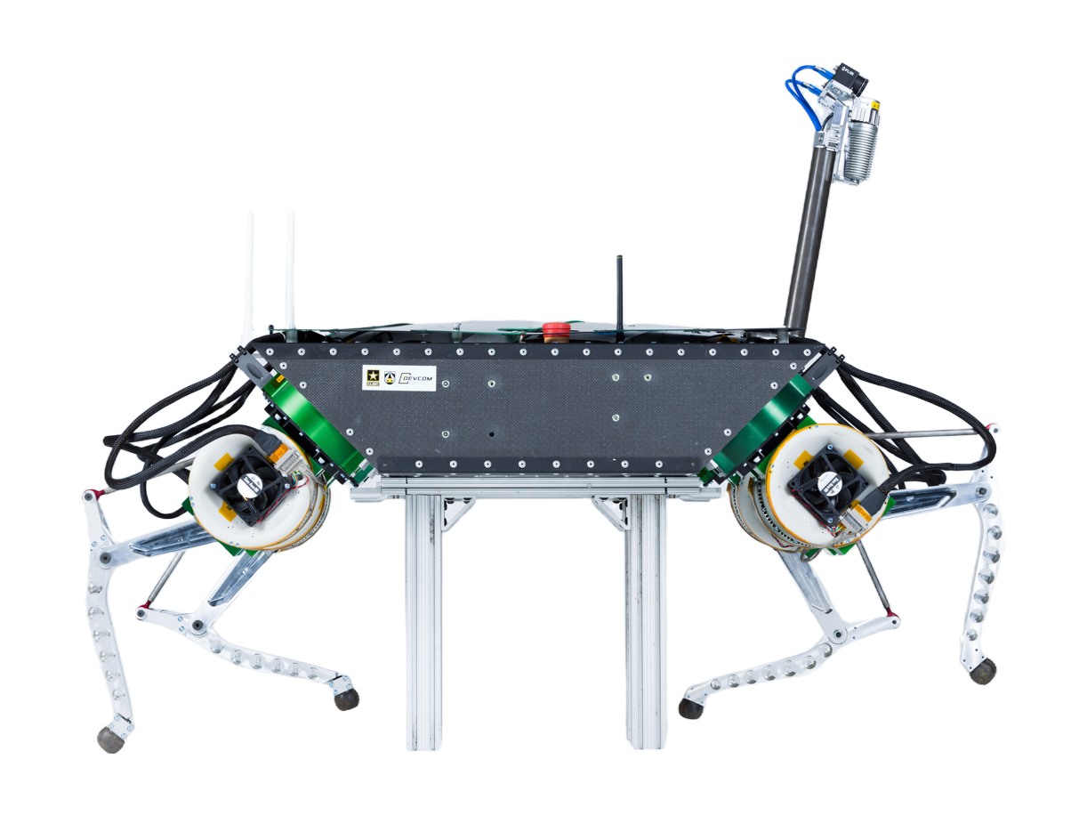 LLAMA, quadruped robot with a flat black body, four legs and an antenna mast, standing on a test stand, JPL studio photo